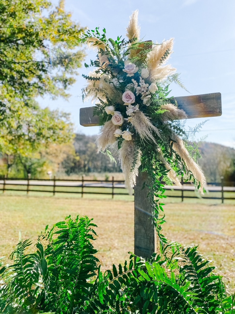 cross wrapped with flowers
